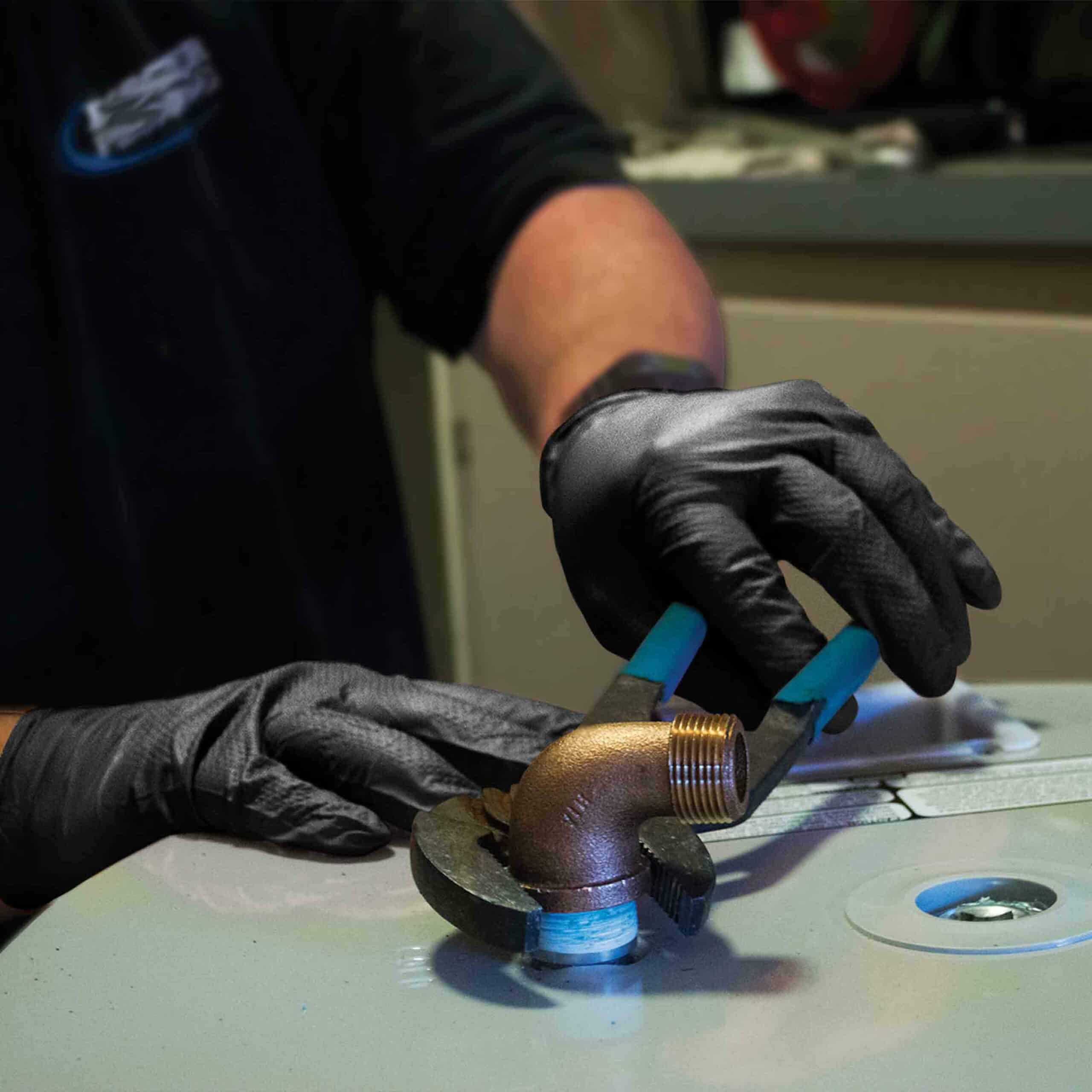 Hands wearing protection gloves using industrial machine for